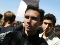 David Hogg and other students from Marjory Stoneman Douglas High School walk out of school to honor the memories of 17 classmates and teachers that were killed during a mass shooting at the school on March 14, 2018 in Parkland, Florida. The students joined others around the country to mark the one-month anniversary of the shooting with a National Walk out day. (Photo by Joe Raedle/Getty Images)
