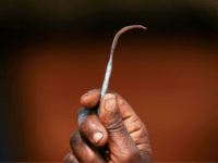 Ex-female genital mutilation (FGM) cutter Monika Cheptilak, who stopped practicing after the country set anti-FGM law in 2010, shows a homemade tool from a nail used for FGM, during the meeting of anti-FGM women group in Alakas village, bordering with Kenya, northeast Uganda on January 31, 2018. The UN estimates that over 200 million girls and women have experienced FGM which is a life-threatening procedure that involves the partial or total removal of a woman's external genitalia. February 6, 2018, marks the 6th International Day of Zero Tolerance for FGM. / AFP PHOTO / Yasuyoshi CHIBA (Photo credit should read YASUYOSHI CHIBA/AFP/Getty Images)