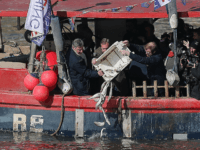 British conservative party member of parliament Jacob Rees-Mogg arrives to attend an event arranged by the pro-Brexit 'Fishing for Leave' group, where fishermen, and former UK Indepence Party (UKIP) Leader Nigel Farage (2L), threw fish into the River Thames from a boat as it sailed past Britain's Houses of Parliament in London on March 21, 2018, to protest against the proposal for Britain to effectively to remain in the Eropean Union's Common Fisheries Policy for almost two years after Brexit day in March 2019. / AFP PHOTO / Daniel LEAL-OLIVAS (Photo credit should read DANIEL LEAL-OLIVAS/AFP/Getty Images)