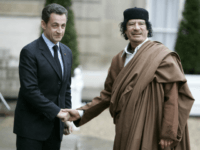 FILE - In this Dec. 10 2007 file photo, French President Nicolas Sarkozy, left, greets Libyan leader Col. Moammar Gadhafi upon his arrival at the Elysee Palace, in Paris. Former French President Nicolas Sarkozy was placed in custody on Tuesday March 20, 2018as part of an investigation that he received millions of euros in illegal financing from the regime of the late Libyan leader Moammar Gadhafi. (AP Photo/Francois Mori)