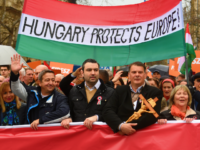 Demonstrators hold a flag in the colors of Hungary reading 'Hungary protects Europe' as they arrive to listen to a speech of their Prime Minister in Budapest on March 15, 2018, as celebrations are under way to commemorates the 170th anniversary of the 1848-1849 Hungarian revolution and independence war on Hungary's National Day. Hungarians took to the streets in separate national day demonstrations to both voice support for, and protest against, Prime Minister Viktor Orban, as an election April 8, 2018 nears. / AFP PHOTO / ATTILA KISBENEDEK STF (Photo credit should read ATTILA KISBENEDEK STF/AFP/Getty Images)