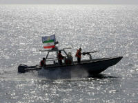 FILE - In this July 2, 2012 file photo, an Iranian Revolutionary Guard speedboat escorts a passenger ship, near the spot where an Iranian airliner was shot down by a U.S. warship 24 years ago killing 290 passengers in Persian Gulf. While U.S. President Donald Trump angered Iran with his speech on refusing to re-certify the nuclear deal, Tehran won't walk away from it in retaliation. (AP Photo/Vahid Salemi, File)