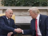 US President Donald Trump (R) shakes hands with newly sworn-in White House Chief of Staff John Kelly