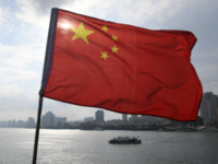A Chinese tour boat cruises on the Yalu River behind the Chinese flag flying on the Broken Bridge, in the border city of Dandong, in China's northeast Liaoning province on September 5, 2017. The Broken Bridge once connected Dandong and the North Korean town of Sinuiju, but was bombed by the US during the Korean war and now only reaches half way across the Yalu River. / AFP PHOTO / GREG BAKER (Photo credit should read GREG BAKER/AFP/Getty Images)