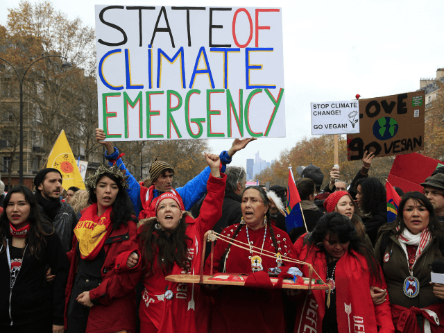 Climate activists demonstrate in Paris, Saturday, Dec.12, 2015 during the COP21, the United Nations Climate Change Conference. Several environmental and human rights groups are planning protests around Paris to call attention to populations threatened by man-made global warming and urge an end to human use of oil, gas and coal. (AP Photo/Thibault Camus)