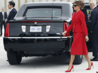 In this July 13, 2017 file photo, Melania Trump, center, walks the tarmac after arriving with President Donald Trump on Air Force One at Orly Airport, south of Paris. Slovenian-born Melania Trump has been unafraid to go against her husband’s “America First” agenda, and stay true to her roots, if there’s a message to be taken from her bold, foreign-flavored first lady wardrobe in 2017. She is wearing a red Dior skirt suit. (AP Photo/Carolyn Kaster)