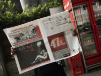 A woman reads a copy of Egyptian newspaper 'Al-Tahrir' with the headline 'No to Dictatorship' on December 3, 2012 in Cairo. A cartoon of a newspaper in human form chained in a cell was pasted on the front of several independent papers including Al-Watan and Al-Masry Al-Youm with the line 'A constitution that cancels rights and shackles freedoms. No to dictatorship'. AFP PHOTO/GIANLUIGI GUERCIA (Photo credit should read GIANLUIGI GUERCIA/AFP/Getty Images)