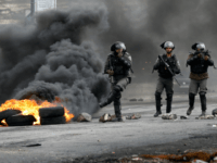 Israeli border guards walk through fumes from burning tires during clashes with Palestinian protesters near the Israeli settlement of Beit El in the Israeli occupied West Bank, on March 30, 2018, after Land Day demonstrations. Land Day marks the killing of six Arab Israelis during 1976 demonstrations against Israeli confiscations of Arab land. / AFP PHOTO / ABBAS MOMANI (Photo credit should read ABBAS MOMANI/AFP/Getty Images)