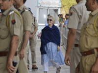 In this Thursday, March 15, 2018 photo, former U.S. Secretary of State Hillary Clinton, center, arrives at the departure terminal of Jodhpur airport in Rajasthan state, India. (AP Photo/Sunil Verma)