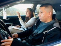 Ramon Maldonado, right, of Phoenix, leaves an Arizona Department of Transportation Motor Vehicle Division office to take his driving test, as many young immigrants protected from deportation under new Obama administration policies begin pursuing Arizona driver's licenses, Monday, Dec. 22, 2014, in Phoenix. Monday is the first day ADOT will start processing driver's license and identification card applications from qualified immigrants. (AP Photo/Ross D. Franklin)
