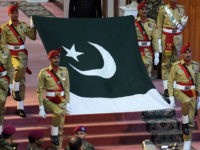 Pakistani soldiers carry national flag during a ceremony to mark the country's Independence Day in Islamabad on August 14, 2017. Pakistans Independence Day, which is annually held on August 14, celebrates the countrys independence from the British rule on that date in 1947. / AFP PHOTO / AAMIR QURESHI (Photo credit should read AAMIR QURESHI/AFP/Getty Images)