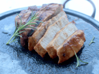 This August 3, 2015 photo shows bourbon pork chop flambe in Concord, NH. The bourbon gravy that is left after the flames burn out flavors every bite of the pork chop. (AP Photo/Matthew Mead)