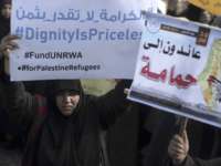 Thousands of employees of the U.N agency for Palestinian refugees demonstrate in support of their organization following U.S. funding cuts in Gaza City, Monday, Jan. 29, 2018. Earlier this month, the Trump administration slashed $60 million of a planned $125 million funding installment for 2018. Washington wants the Palestinian Authority to return to the negotiating table with Israel in exchange for aid resumption. Arabic at right reads “Returning to Hamama village.” (AP Photo/ Khalil Hamra)