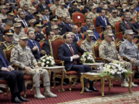 In this photo released by the Egyptian Presidency, Egyptian President Abdel-Fattah el-Sissi, center, attends a conference commemorating the country's martyrs, in Cairo, Egypt, Thursday, March 15, 2018. Up for re-election in less than two weeks, Egypt's president on Thursday took center stage at a televised ceremony declaring his readiness to personally join the battle against militants and decorating soldiers and families of fallen ones. (Sherif Abdel Meniom/Egyptian Presidency via AP)