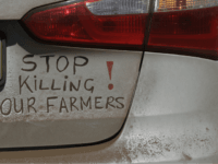 A bumper sign during a blockade of the freeway between Johannesburg and Vereeniging, in Midvaal, South Africa, in protest against the recent murder of farmers, Monday, Oct 30 2017. Traffic was bought to a standstill on highways leading from farming areas to Cape Town, Pretoria and Johannesburg, as white farmers protest in what they call the Black Monday protest against the high rate of murders of farmer workers. (AP Photo/Themba Hadebe)