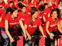 women participating in a spin class