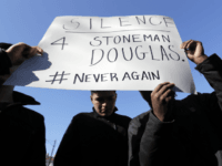 Students participate in a walkout to protest gun violence at Lincoln Park High School in response to last month's massacre of 17 people at Florida's Marjory Stoneman Douglas High School, Wednesday, March 14, 2018, in Chicago. (AP Photo/Nam Y. Huh)