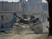 A Syrian army tank rolls into the formerly rebel-held area of Beit Nayem in Eastern Ghouta on March 6, 2018