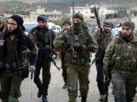Turkish-backed Syrian rebels enter the village of Qastal Koshk, north of Afrin, on March 16, 2018 following battles with Kurdish fighters