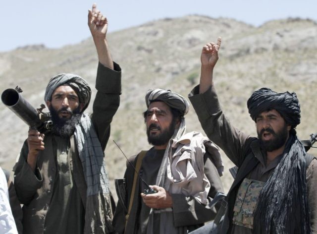 In this May 27, 2016 file photo, Taliban fighters react to a speech by their senior leader in the Shindand district of Herat province, Afghanistan. With U.S. support, the Afghan government has made a surprising new peace offer to the Taliban, only to immediately run into a wall. The insurgents …