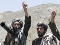 In this May 27, 2016 file photo, Taliban fighters react to a speech by their senior leader in the Shindand district of Herat province, Afghanistan. With U.S. support, the Afghan government has made a surprising new peace offer to the Taliban, only to immediately run into a wall. The insurgents show no sign of shifting from their demand that talks for a conflict-ending compromise take place with Washington, not Kabul. (AP Photos/Allauddin Khan, File)