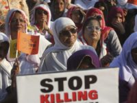 A Pakistani acid attack victim, center, takes part in a rally to mark International Women's Day in Karachi, Pakistan, Thursday, March 8, 2018. (AP Photo/Fareed Khan)