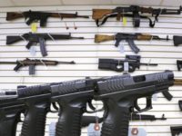 FILE--In this Jan. 16, 2013, file photo, assault weapons and hand guns are seen for sale at Capitol City Arms Supply in Springfield, Ill. Recent mass shootings spurred Congress to try to improve the background check system used during gun purchases, but experts say the system is so fractured that federal legislation being considered in Washington D.C. will do little to help keep weapons out of the hands of dangerous people. (AP Photo/Seth Perlman, file)