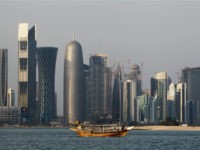 FILE - In this Thursday Jan. 6, 2011 file photo, a traditional dhow floats in the Corniche Bay of Doha, Qatar, with tall buildings of the financial district in the background. Qatar's government says it is forming a committee to pursue compensation for damages stemming from its isolation by four Arab countries. (AP Photo/Saurabh Das, File)