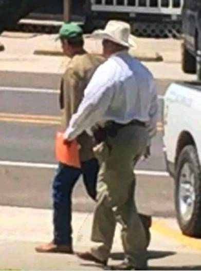 San Jacinto County Sheriff Greg Capers escorts arrested County Judge John Lovett from the courthouse to the jail. (Photo: San Jacinto County News)