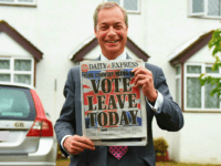 WESTERHAM, ENGLAND - JUNE 23: Nigel Farage, leader of UKIP and Vote Leave campaigner holds up the 'Daily Express' as he returns to his home after buying newspapers of the United Kingdom on June 23, 2016 in Westerham, England. The United Kingdom is going to the polls to decide whether or not the country wishes to remain within the European Union. After a hard fought campaign from both REMAIN and LEAVE the vote is too close to call. A result on the referendum is expected on Friday morning. (Photo by Mary Turner/Getty Images)