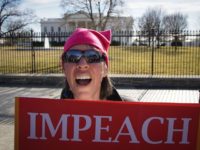 An activist holds a placard during the People's March on Washington infront of the White House on January 27, 2018 in Washington, DC. / AFP PHOTO / MANDEL NGAN (Photo credit should read MANDEL NGAN/AFP/Getty Images)