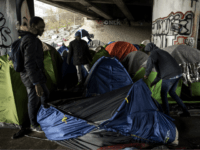 Migrants set up a tent at a makeshift camp set under a bridge along the canal de Saint-Denis in Paris on March 29, 2018. / AFP PHOTO / CHRISTOPHE ARCHAMBAULT (Photo credit should read CHRISTOPHE ARCHAMBAULT/AFP/Getty Images)