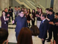 This picture released from North Korea's official Korean Central News Agency (KCNA) on April 2, 2018 and taken on April 1, 2018 shows North Korean leader Kim Jong Un (centre L) speaking to South Korean musicians as his wife Ri Sol-Ju (far L) and South Korea's Culture, Sports and Tourism Minister Do Jong-whan (centre R) look on, after a rare concert by South Korean musicians at the 1,500-seat East Pyongyang Grand Theatre in Pyongyang. Top South Korean musical acts including a K-pop girlband held a rare concert in North Korea on April 1 in the latest reconciliatory gesture before a rare inter-Korean summit. / AFP PHOTO / KCNA VIA KNS / KCNA VIA KNS / South Korea OUT / REPUBLIC OF KOREA OUT ---EDITORS NOTE--- RESTRICTED TO EDITORIAL USE - MANDATORY CREDIT 'AFP PHOTO/KCNA VIA KNS' - NO MARKETING NO ADVERTISING CAMPAIGNS - DISTRIBUTED AS A SERVICE TO CLIENTS THIS PICTURE WAS MADE AVAILABLE BY A THIRD PARTY. AFP CAN NOT INDEPENDENTLY VERIFY THE AUTHENTICITY, LOCATION, DATE AND CONTENT OF THIS IMAGE. THIS PHOTO IS DISTRIBUTED EXACTLY AS RECEIVED BY AFP. / (Photo credit should read KCNA VIA KNS/AFP/Getty Images)