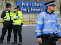Police officers stand near the Ferry terminal as anti-racism demonstrators block the route of a planned far right march through Dover, southern England, on April 2, 2016. / AFP / JUSTIN TALLIS (Photo credit should read JUSTIN TALLIS/AFP/Getty Images)