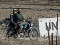 A picture taken from the Israeli-occupied Golan Heights shows armed men, reportedly rebel fighters, driving a motorcycle near an abandoned UN building in the Syrian side of the Golan Heights, at an abandoned UN base at the Quneitra border crossing, on November 28, 2016. Israel's air force targeted gunman linked to the Islamic State group in Syria overnight, the army said, after they fired on an Israeli soldier in the occupied Golan Heights. / AFP / JACK GUEZ (Photo credit should read JACK GUEZ/AFP/Getty Images)