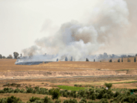 Smoke and flames rise from fields near the Kibbutz Beeri on the Israeli side of the border with the Gaza Strip east of Gaza City, after Palestinians flew a kite laden with a molotov cocktail over the border before cutting the string leaving the burning material to fall in Israeli territory on April 17, 2018. / AFP PHOTO / MAHMUD HAMS (Photo credit should read MAHMUD HAMS/AFP/Getty Images)
