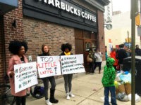 Protesters gather outside a Starbucks in Philadelphia, Sunday, April 15, 2018, where two black men were arrested Thursday after Starbucks employees called police to say the men were trespassing. The arrest prompted accusations of racism on social media. Starbucks CEO Kevin Johnson posted a lengthy statement Saturday night, calling the situation 