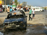 Iraqis check the damage at the site of an attack involving a moped laden with explosives against a convoy carrying an Iraqi election candidate in the city of Kirkuk, a multiethnic flashpoint some 250 kilometres (155 miles) north of Baghdad, on April 15, 2018. / AFP PHOTO / Marwan IBRAHIM (Photo credit should read MARWAN IBRAHIM/AFP/Getty Images)