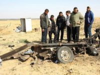 Palestinian men look at the debris of a tuk tuk vehicle at the site of an explosion east of Rafah in the southern Gaza Strip, on April 14, 2018. Four members of Islamic Jihad died in the blast (AFP PHOTO / SAID KHATIB)