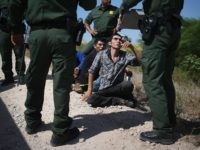 MCALLEN, TX - AUGUST 07: U.S. Border Patrol agents detain undocumented immigrants after they crossed the border from Mexico into the United States on August 7, 2015 in McAllen, Texas. The state's Rio Grande Valley corridor is the busiest illegal border crossing into the United States. Border security and immigration have become major issues in the U.S. presidential campaigns. (Photo by John Moore/Getty Images)