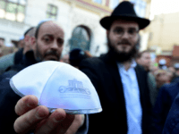 A man shows a kippa during the 'Berlin wears kippa' event, with more than 2,000 Jews and non-Jews wearing the traditional skullcap to show solidarity with Jews on April 25, 2018 in Berlin after Germany has been rocked by a series of anti-Semitic incidents. - Germans stage shows of solidarity with Jews after a spate of shocking anti-Semitic assaults, raising pointed questions about Berlin's ability to protect its burgeoning Jewish community seven decades after the Holocaust. (Photo by Tobias SCHWARZ / AFP) (Photo credit should read TOBIAS SCHWARZ/AFP/Getty Images)
