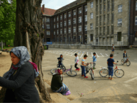 BERLIN, GERMANY - MAY 03: Residents of a shelter for refugees and migrants in Marienfelde district relax in the courtyard of the shelter, which was previously an administrative building for a supermarket chain, on May 3, 2017 in Berlin, Germany. The shelter currently houses approximately 450 people, the majority of whom are still waiting for their asylum applications to be processed. Most of the residents come from countries including Syria, Iraq, Afghanistan and Iran, as well as Lebanon, Turkey and Chechnya, and half of them are under 18, as the shelter only admits families. Most of the children go to local schools and German has become their common language. Germany took in over one million refugees and migrants between 2015 and 2016. (Photo by Sean Gallup/Getty Images)