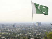 ISLAMABAD, PAKISTAN - MARCH 14: An aerial view of city scape is seen as a Pakistani flag is wawing in Islamabad, Pakistan on March 14, 2018. City staff prepared the city surroundings for being ready for celebrations of 23rd March Pakistan's National Day. Islamabad, being the capital city of Pakistan till 60s, is sectored in grids via trees in clean streets. Pakistan located on the Himalayan foothills and the Margalla Hills. There are many historical and significant places like the Faisal Mosque, Rawal Dam, Damanico Hill. (Photo by Muhammed Semih Ugurlu/Anadolu Agency/Getty Images)