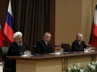 Iran's President Hassan Rouhani, left, Russia's President Vladimir Putin, right, and Turkey's President Recep Tayyip Erdogan speak during a joint press conference in Ankara, Turkey, Wednesday, April 4, 2018. The leaders of Russia, Turkey and Iran say they stand against 