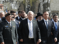 Poland's President Andrzej Duda, left, and Israel's President Reuven Rivlin, center, walk in the March of the Living, a yearly Holocaust remembrance march between the former death camps of Auschwitz and Birkenau, in Oswiecim, Poland, on Thursday, April 12, 2018. (AP Photo/Czarek Sokolowski)