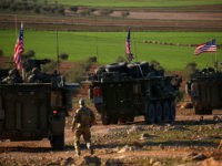 A convoy of US forces armoured vehicles drives near the village of Yalanli, on the western outskirts of the northern Syrian city of Manbij, on March 5, 2017. / AFP PHOTO / DELIL SOULEIMAN (Photo credit should read DELIL SOULEIMAN/AFP/Getty Images)