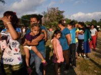 Central American migrants taking part in the Migrant Via Crucis caravan toward the United States queue for food at a sports field in Matias Romero, Mexico, on April 3, 2018