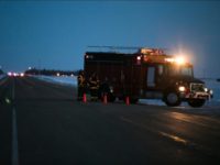 An emergency vehicle is seen near the crash site on April 6, 2018 after a bus carrying a junior ice hockey team collided with a semi-trailer truck between Tisdale and Nipawin, Saskatchewan province, killing 14 people