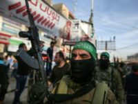 A member of Hamas's armed wing stands guard during a funeral in the Gaza Strip on March 22, 2018