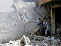 Syrian soldiers inspect the wreckage of a building described as part of the Scientific Studies and Research Centre (SSRC) compound in the Barzeh district, north of Damascus, on April 14, 2018